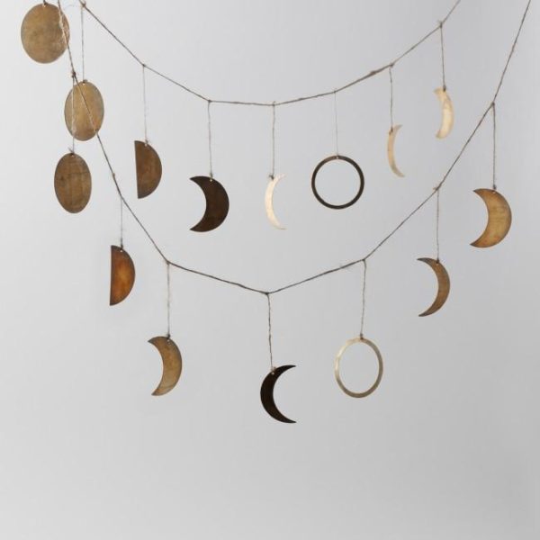 all the phases of the moon in brass strung on jute twine