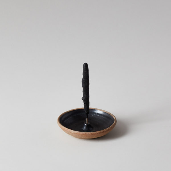 Rustic and hand-thrown pottery incense holder with incense wand