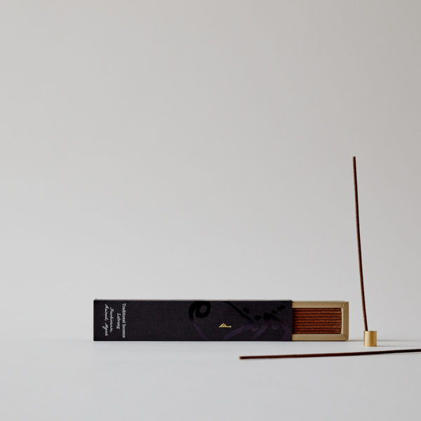 open box of incense with one stick in holder